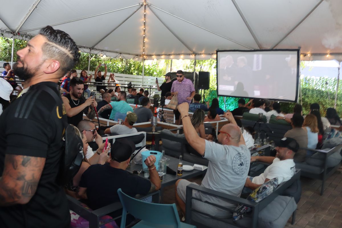 Wide crowd of Premier League fans watching the match on the big projection screen at the Grails Miami patio in Miami