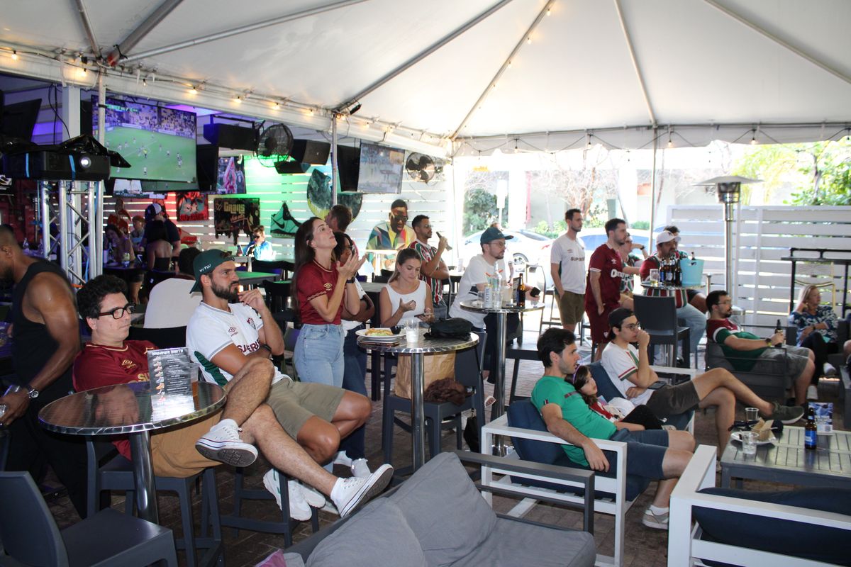 Large group of Fluminense fans watching a Brasileirão match on the Grails Miami patio