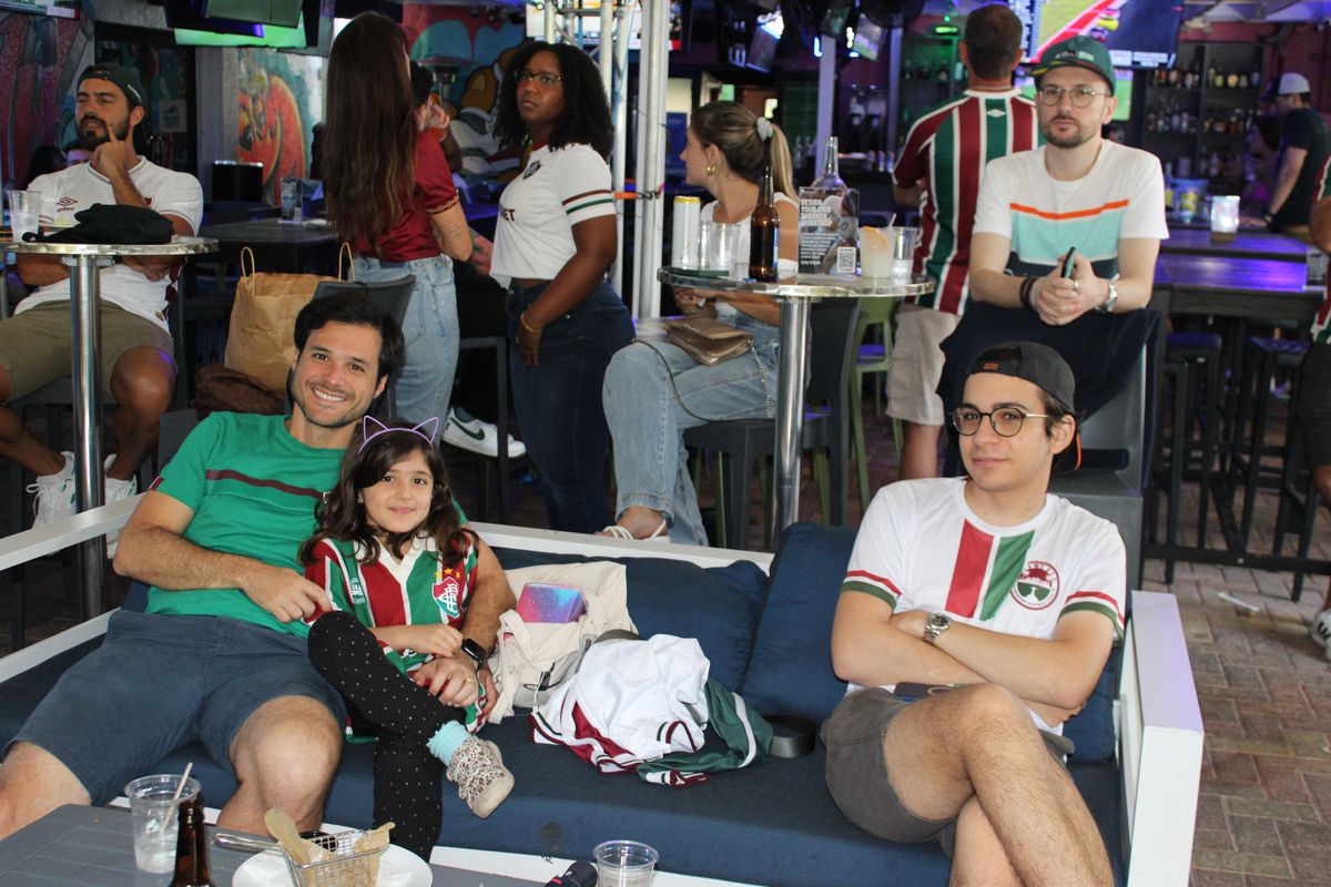 Fluminense fan family watching a Brasileirão match at Grails Miami (family-friendly venue)
