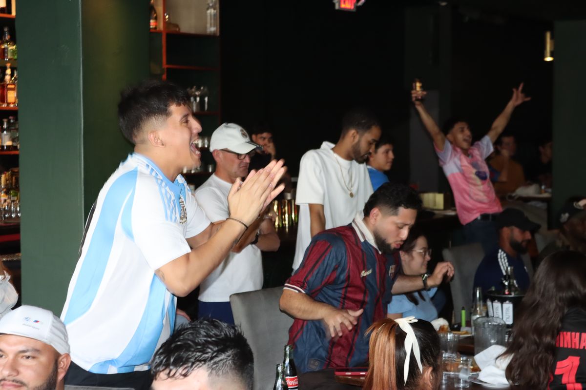 Young soccer fan in a national-team jersey clapping during a Concacaf Champions Cup match at Grails Miami