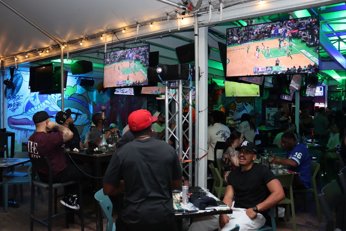 Miami Vice Patio covered bar with TVs and Wynwood happy hour crowd at Grails Miami