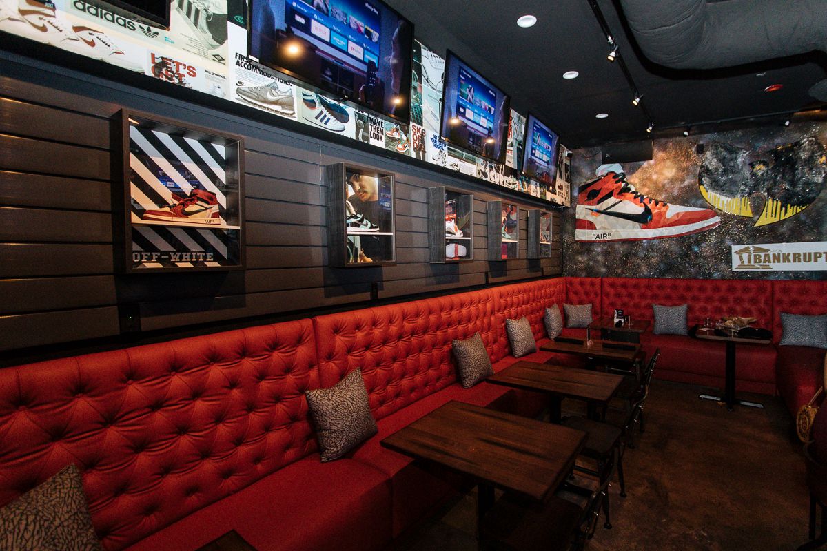 Sneaker Lounge red banquettes and sneaker wall display at Grails Miami in Wynwood