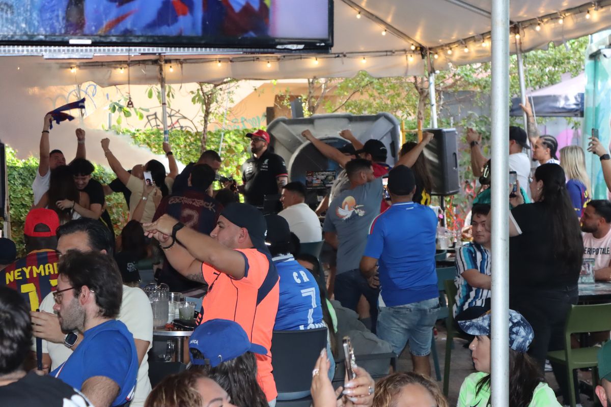 Packed crowd of soccer fans cheering on the patio at Grails Miami, Miami's home World Cup watch party bar