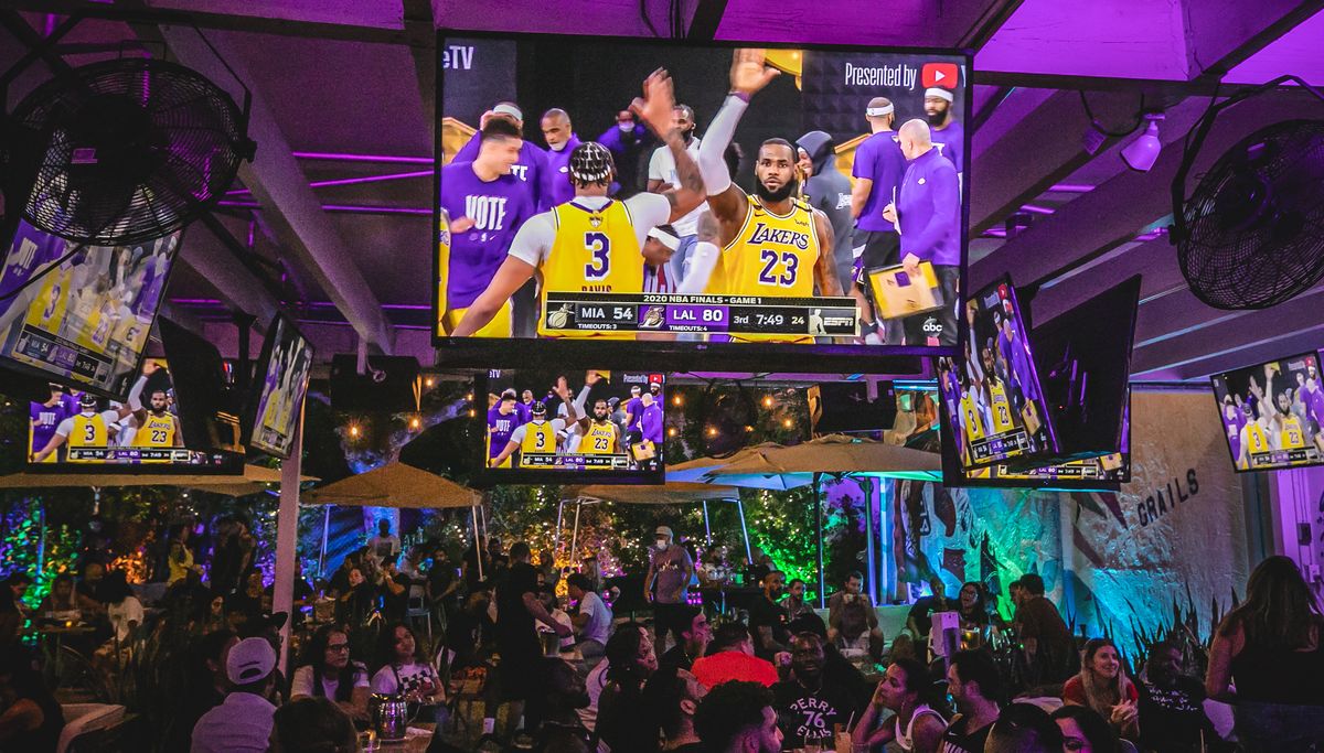 NBA Finals Lakers vs Heat broadcast on the big screen above a packed Grails Miami watch party crowd