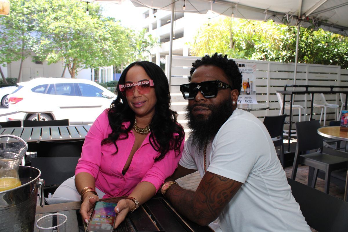 Couple posing at Grails Miami patio in daytime