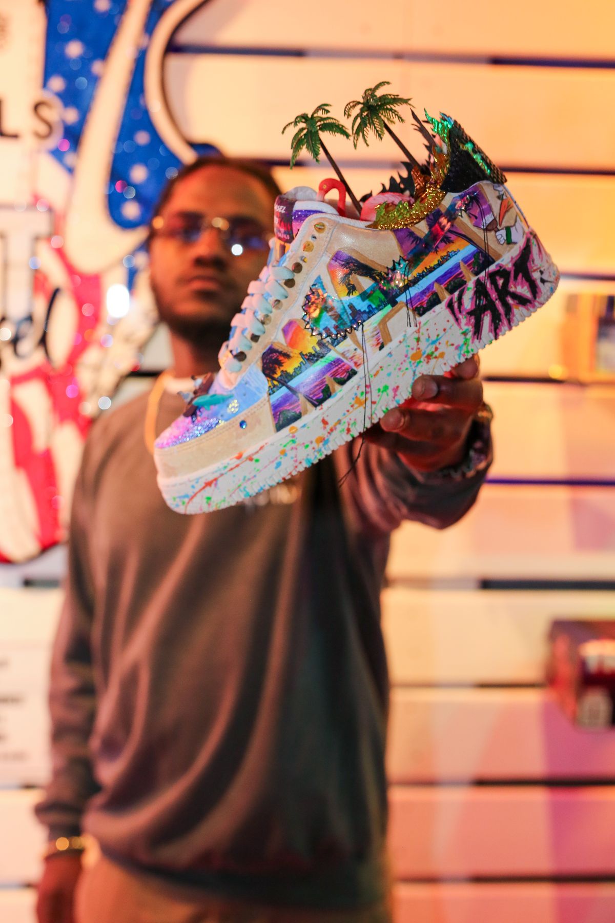 Custom Miami-themed Grails sneaker cocktail held up at Grails Miami in Wynwood