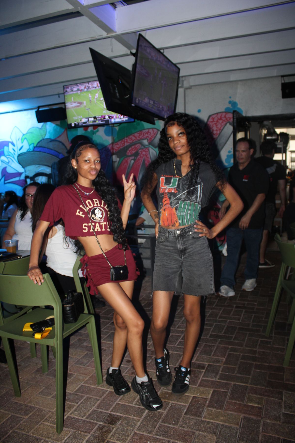 Florida State and Miami Hurricanes fans side by side on the covered patio at Grails Miami on rivalry Saturday