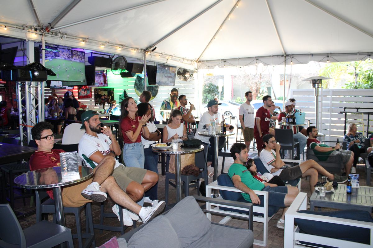 Large group of Fluminense fans watching a Brasileirão match on the Grails Miami patio