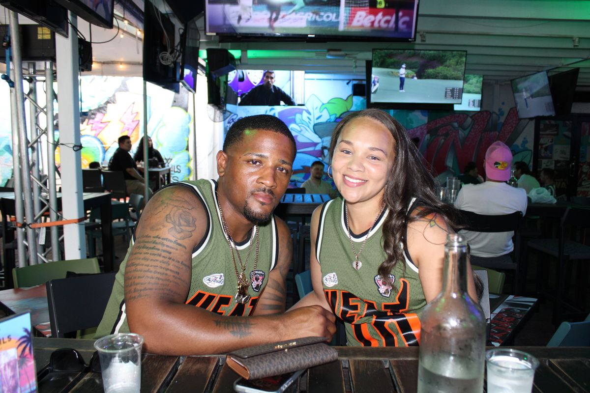 Couple in matching Miami Heat NBA Finals jerseys at the Grails Wynwood bar during a Heat watch party