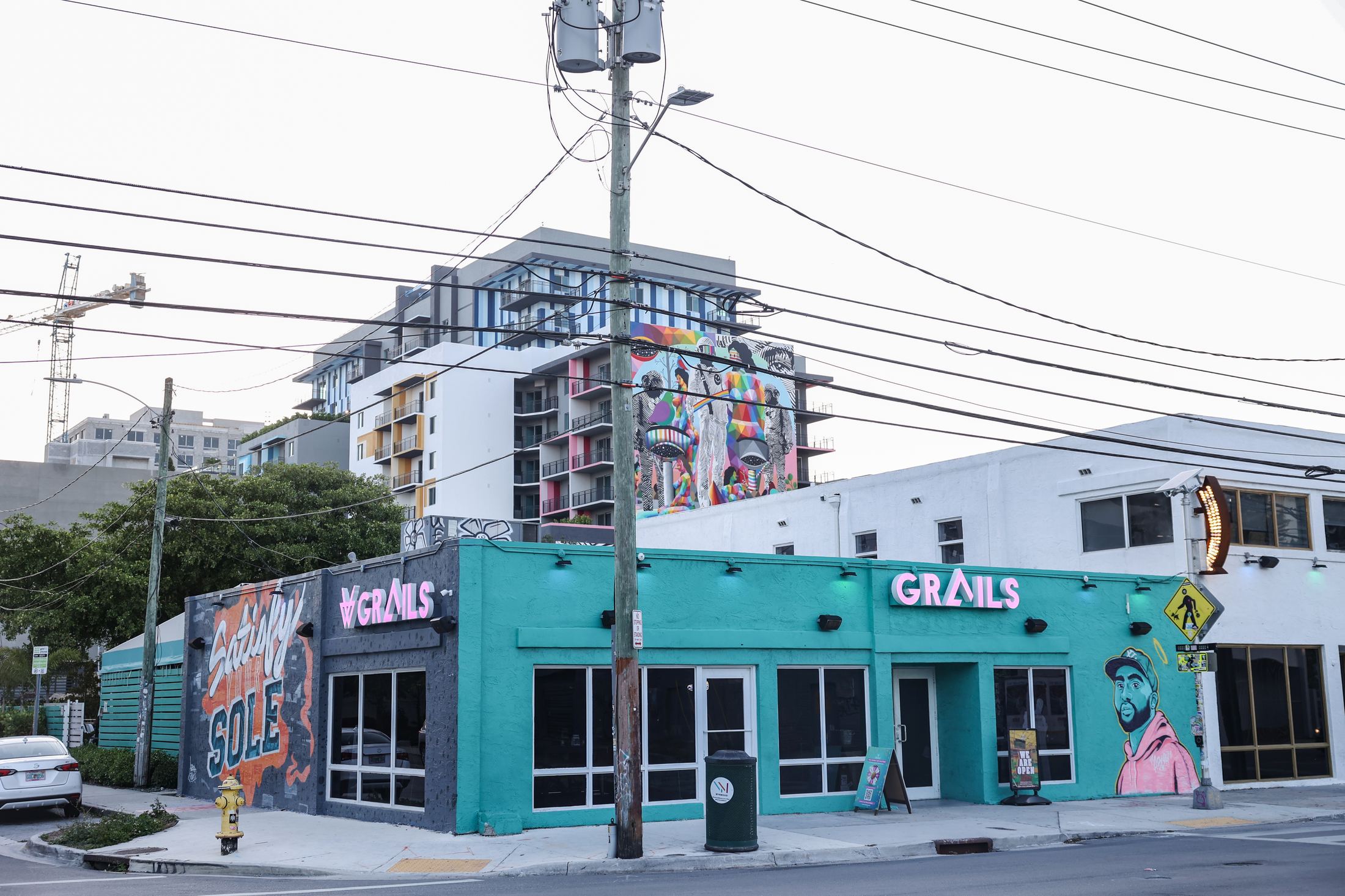 Grails Miami's teal corner storefront with pink neon signage on N Miami Ave, two blocks from Wynwood Walls.