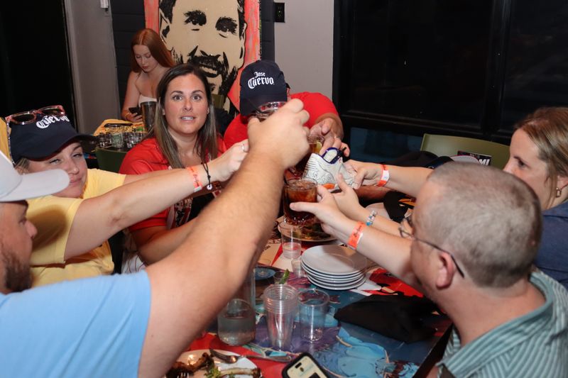 Friends toasting the famous Grails sneaker cocktail in Wynwood