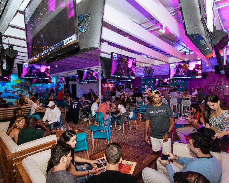 Grails Miami interior with patrons at lounge seating and bar
