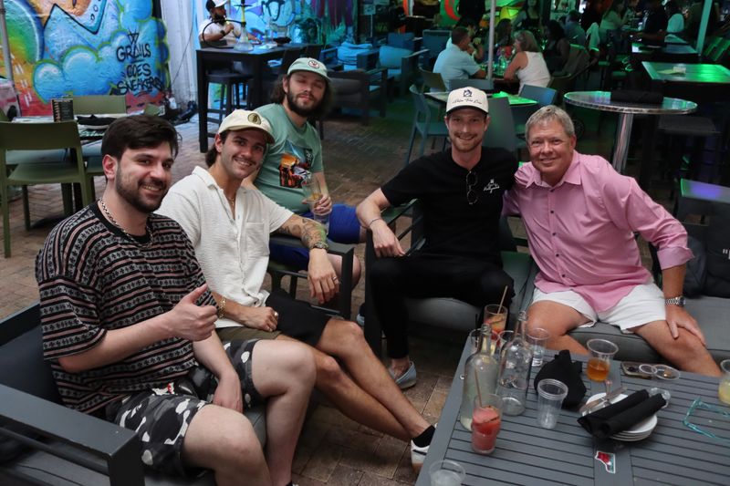 Five friends at the covered Miami Vice patio at Grails Miami with cocktails