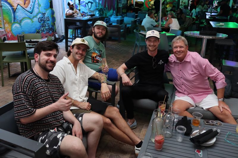 Five friends at the covered Miami Vice patio at Grails Wynwood with cocktails